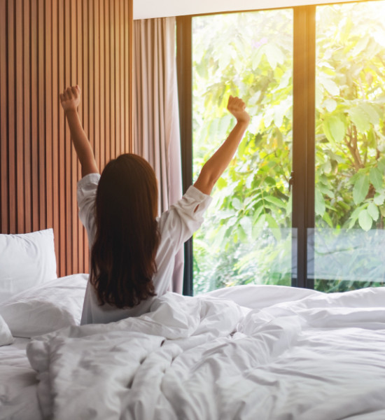 rear-view-woman-stretching-after-waking-up-morning-looking-beautiful-nature-view-outside-bedroom-window