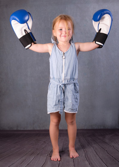 little-girl-like-champion-with-hands-up-kids-sports-concept